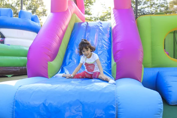 Girl on the trampoline slide — Stock Photo, Image
