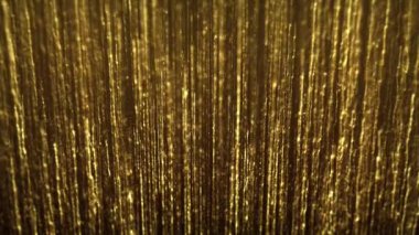 Abstract Gold Filaments Bursting Background/ 4k animation of an abstract wallpaper background of bursting gold filaments lines and particles sparkling with glimmer fx and depth of field