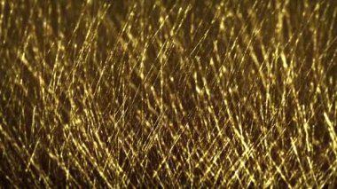 Abstract Gold Filaments Bursting Background/ 4k animation of an abstract wallpaper background of bursting gold filaments lines and particles sparkling with glimmer fx and depth of field
