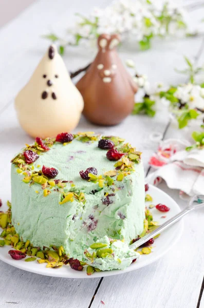 Curd Easter with pistachios and dried cherries. Traditional Russian Easter cottage cheese dessert. Easter food background. Traditional cottage cheese pie with pistachio and cherry. Paskha, kulich and Easter cake.