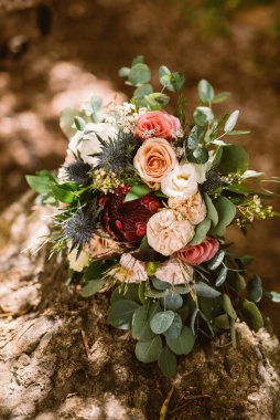 Wedding bouquet outside on the rock