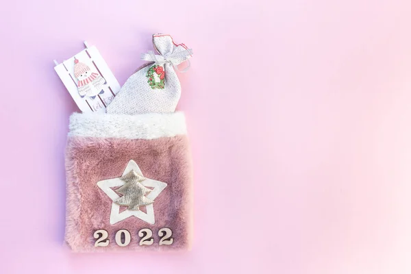 Christmas bag with gifts on a pink background — Stock Photo, Image