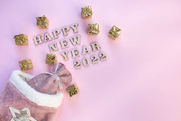 Christmas bag with gifts on a pink background — Stock Photo, Image