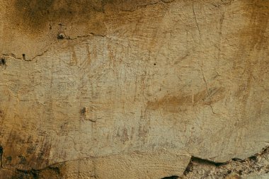 Grunge brown old stone background, cracked texture.