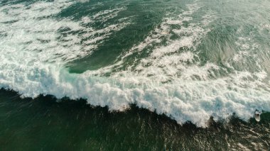 aerial drone view of the beach with wave on the sea coast of the island.