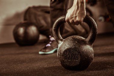 Fitness concept with kettlebell, dumbbells. sport background on the gym, strength training.