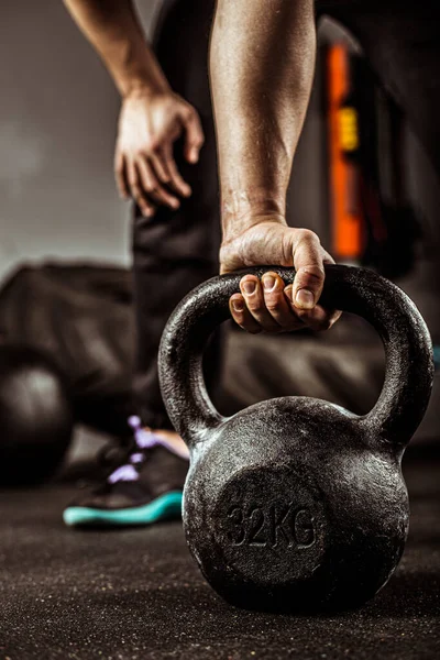 Fitness concept with kettlebell, dumbbells. sport background on the gym, strength training.