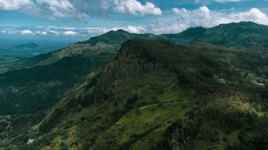 Beautiful mountain landscape with green mountains and blue sky.