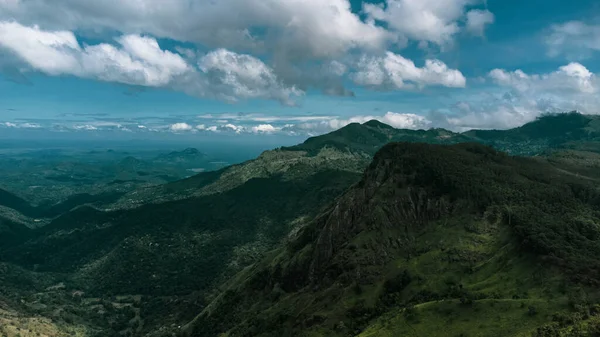 Beautiful mountain landscape with green mountains and blue sky.
