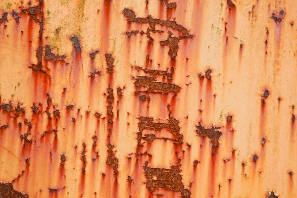 Part of old weathered metal with orange paint — Stock Photo, Image