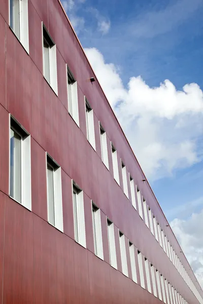 Red wall of office building and clouds — Stock Photo, Image