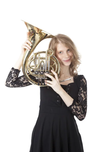 Young pretty woman holding french horn — Stock Photo, Image