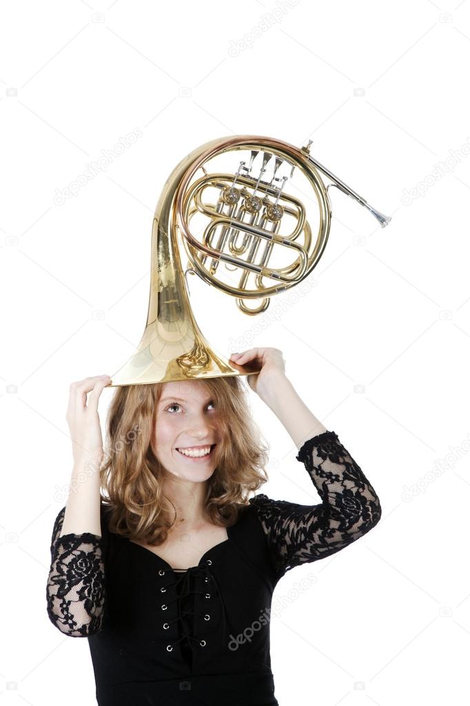 young woman playing with french horn