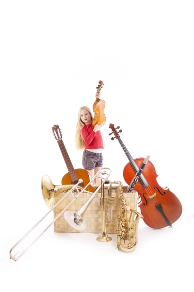 Jovem com muitos instrumentos musicais na caixa — Fotografia de Stock
