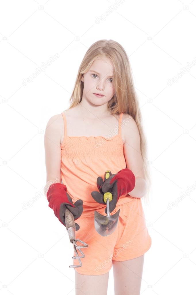 young girl in studio with gardening tools