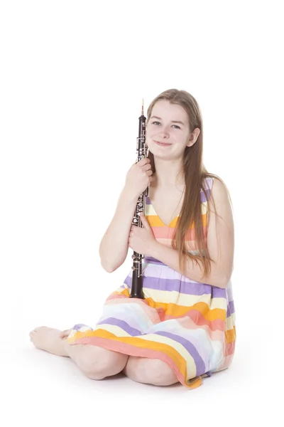Sitting girl with oboe against white background — Stock Photo, Image