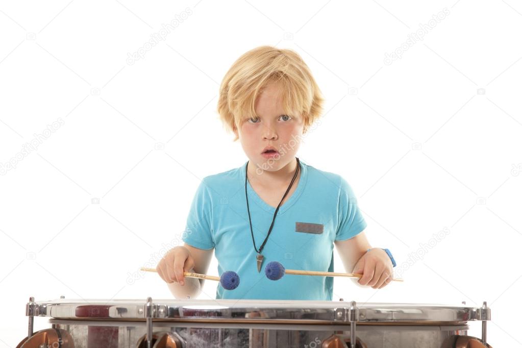 young boy playing kettledrum