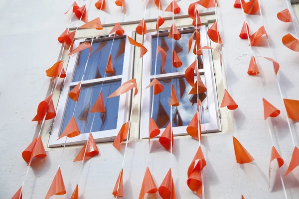Orange flags against white wall — Stock Photo, Image