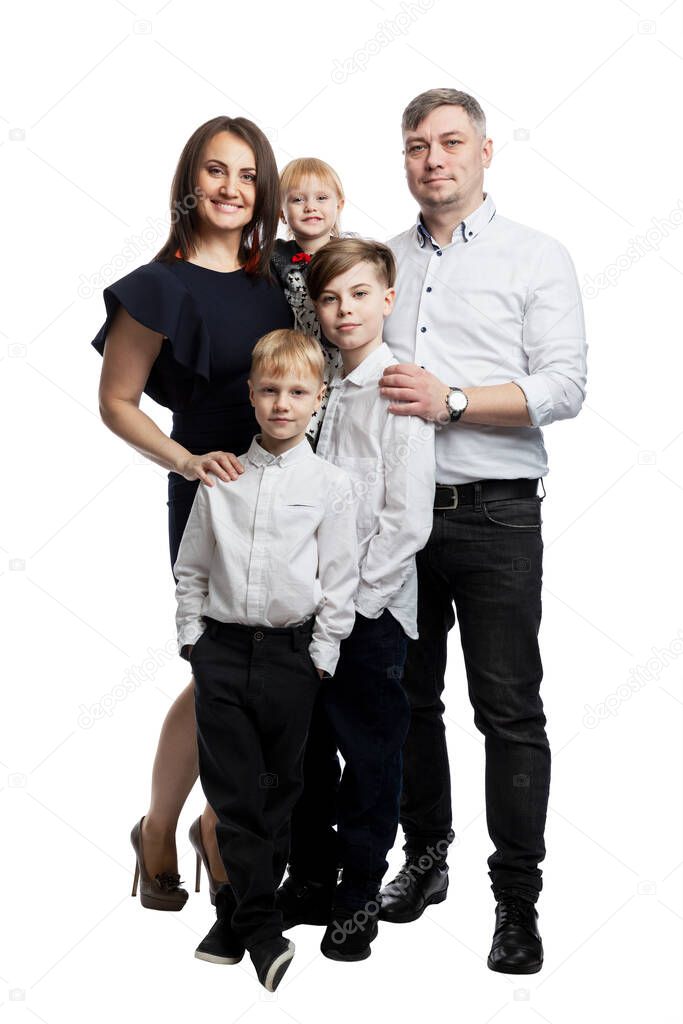 A family with three young children. Mom, dad, two sons and a daughter. Full height. Family relationships. love and tenderness. Isolated on white background. Vertical.
