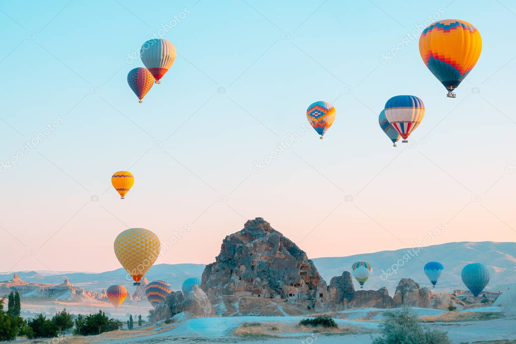 Hot air balloons and fairy chimneys in Cappadocia Turkey. Cappadocia background photo. Hot air balloon activity in Goreme. 