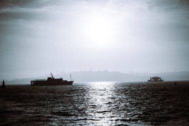 Monochrome Istanbul background photo. Ferry and cityscape of Istanbul at foggy weather. Travel to Turkey.