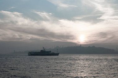 Istanbul background. Silhouette of ferry and cityscape of Istanbul at sunset with foggy weather. Istanbul background photo.