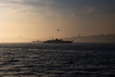 Moody Istanbul background. Silhouette of ferry and cityscape of Istanbul. Galata tower and mosques. 