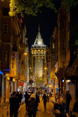 Galata Tower. People and Galata Tower at night in Istanbul. Tourism in Turkey vertical story background. Istanbul Turkey - 10.15.2021