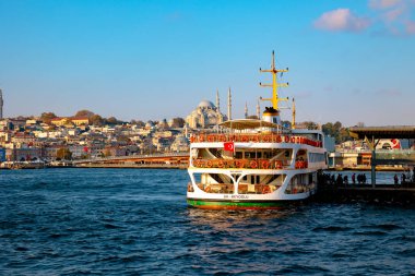 Istanbul and Ferry. A ferry near the Karakoy Pier and Suleymaniye Mosque in the morning. Istanbul Turkey - 10.13.2021