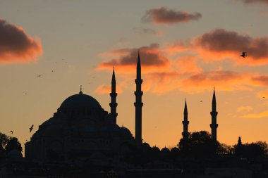 Istanbul mosques. Silhouette of Suleymaniye Mosque at sunset. Ramadan or iftar or kandil or laylat al-qadr or islamic background photo. Noise effect included.