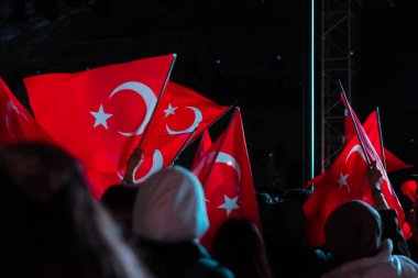 Türk halkı, ulusal günlerin gece kutlanmasında bayraklarını sallıyor. Türk bayrakları ve insanları. Türkiye 'nin ulusal arkaplan günleri. Gürültü ve hareket bulanıklığı da dahil. seçici odak.