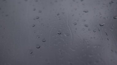 Raindrops falling over the window. Moody rainy day background video