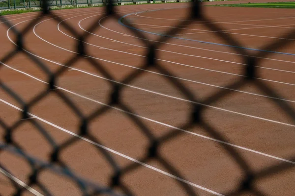 Running tracks behind the fences. Sport background photo. Banned from olympics or using doping concept background photo.