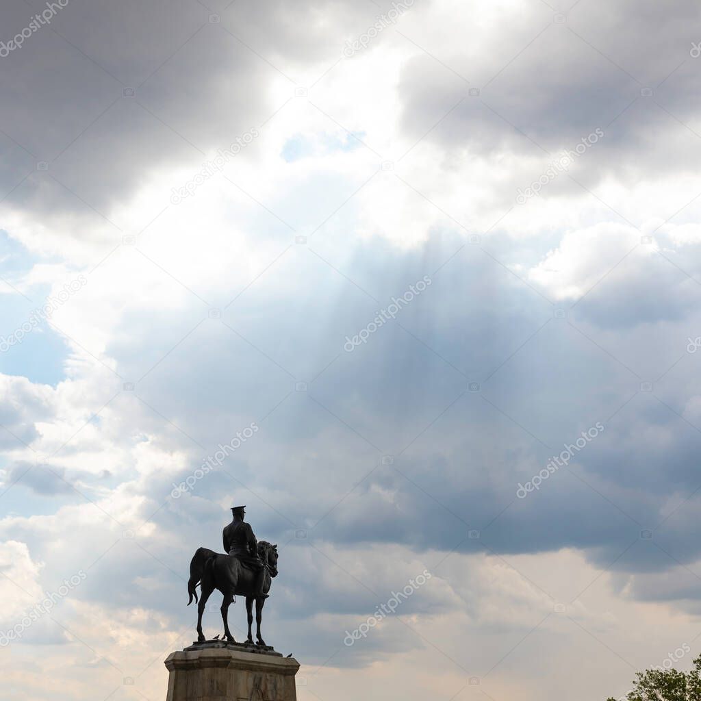 Silhouette of the monument of Ataturk in Ankara and sunrays in the clouds. Turkish public days background square format photo with copy space.