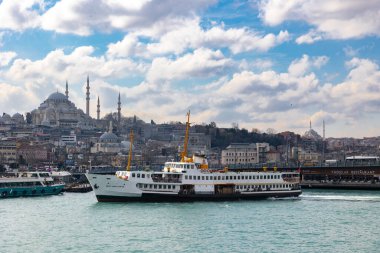 Istanbul. Ferry and Suleymaniye Mosque view with cloudy sky. Istanbul Turkey - 3.2.2022