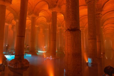 The Basilica Cistern or Yerebatan Sarnici with orange ambient light. Travel to Istanbul background photo. Noise and grain included. Selective focus. Istanbul Turkey - 8.3.2022