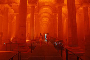 Basilica Cistern or Yerebatan Sarnici with orange ambient lights. Travel to Istanbul background photo. Noise and grain included. Selective focus. Istanbul Turkey - 8.3.2022