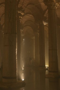 Moody interior view of Basilica Cistern or Yerebatan Sarnici. Travel to Turkey concept photo. Noise and grain included. Selective focus. Istanbul Turkey - 8.3.2022