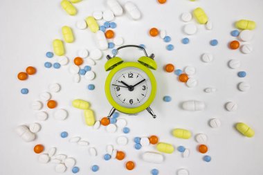 Alarm clock and medicines. Time to taking pills concept photo. Using medicines background.