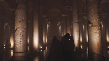 Tourists in the Basilica Cistern or Yerebatan Sarnici. Travel to Istanbul background 4k video. Noise included. Istanbul Turkey - 8.3.2022