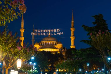 Sultanahmet Mosque or Blue Mosque at night. Islamic or ramadan background photo. Mohammad the messenger of god on the text. Selective focus. Noise and grain included.