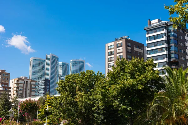 Cityscape from a park. Modern buildings and parks in the city. Economy or clean cities or sustainable life or carbon net zero concept photo. Kadikoy district of Istanbul.