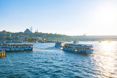 Galata Köprüsü 'nden İstanbul manzarası. Yazın gün batımında Haliç ve Süleyman Camii 'ndeki feribotlar. İstanbul Türkiye - 8.20.2022