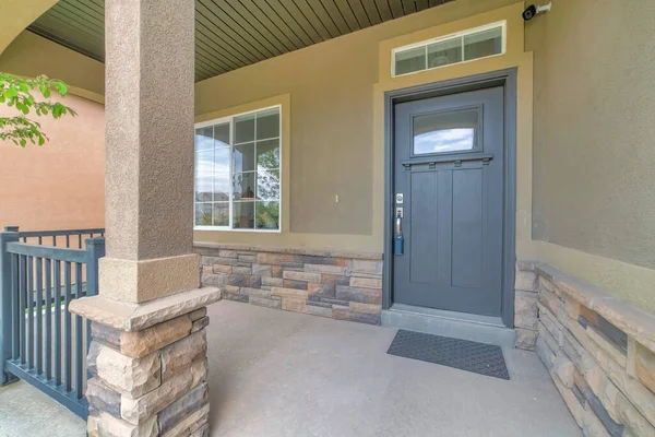 Front porch with security camera above the gray front door with window panel and lockbox — Stock Photo, Image