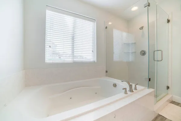 Banheira e chuveiro sem moldura com parede de mármore branco envolvente — Fotografia de Stock