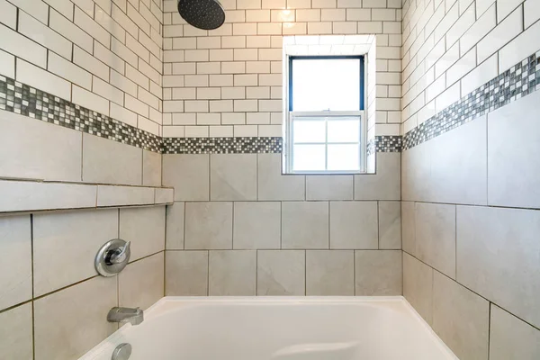 Alcove badkuip douche combo met keramische en metro tegels muur met mozaïek tegels trim in het midden — Stockfoto