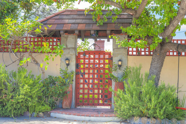 Arbor gate with two wall lamps on the concrete posts at La Jolla, San Diego, California