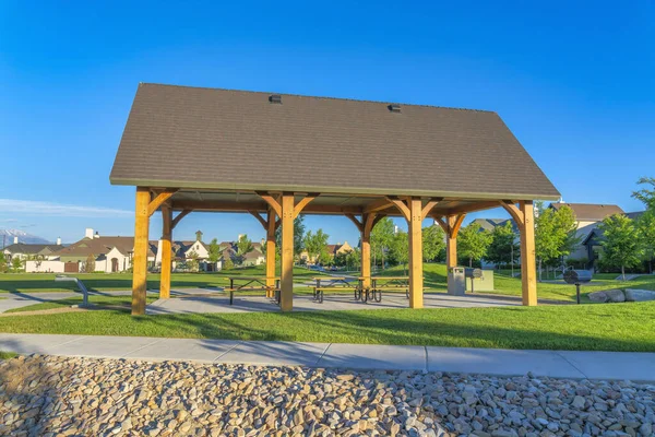 Pavilion with asphalt shingle roof and wooden columns at Daybreak, South Jordan, Utah
