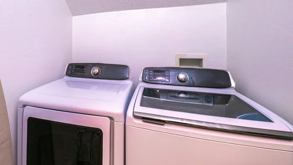 Panorama Small tight laundry room with slope ceiling and laundry appliances — Stock Photo, Image