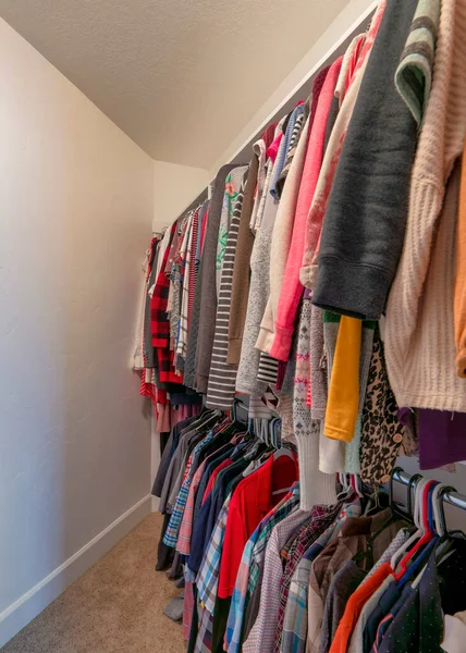 Vertical pequeño armario interior con ropa colgante de colores — Foto de Stock